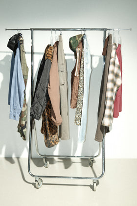 Clothing rack with various garments from Stüssy FW25.