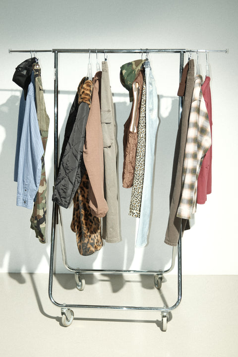Clothing rack with various garments from Stüssy FW25.